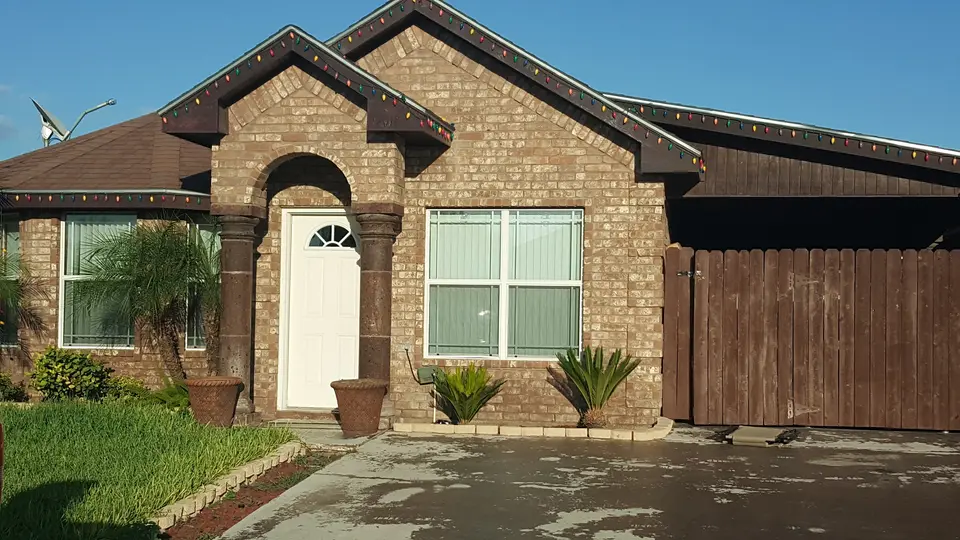 Completed Better Builders brick home featuring a contrasting gable and arched front entrance.