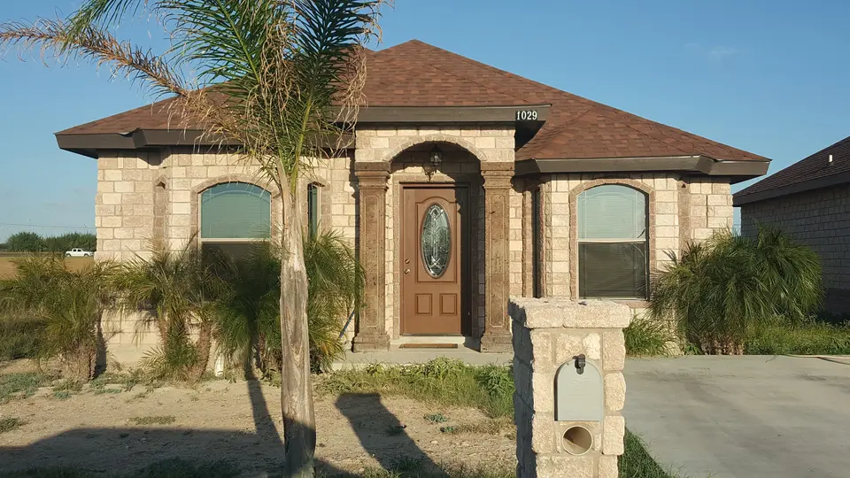 Stone-front home with palm landscaping