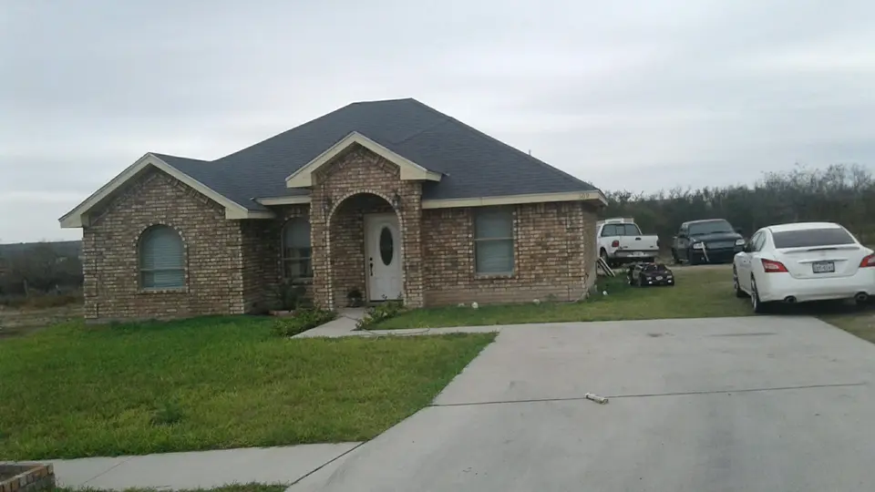 Completed Better Builders brick home with a stone-framed arched entrance.