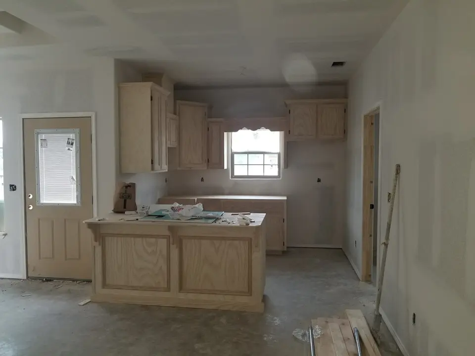 Custom kitchen cabinets and island being installed inside a Better Builders home.