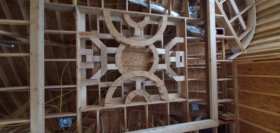 Geometric custom wood ceiling framework being built inside a Better Builders home.