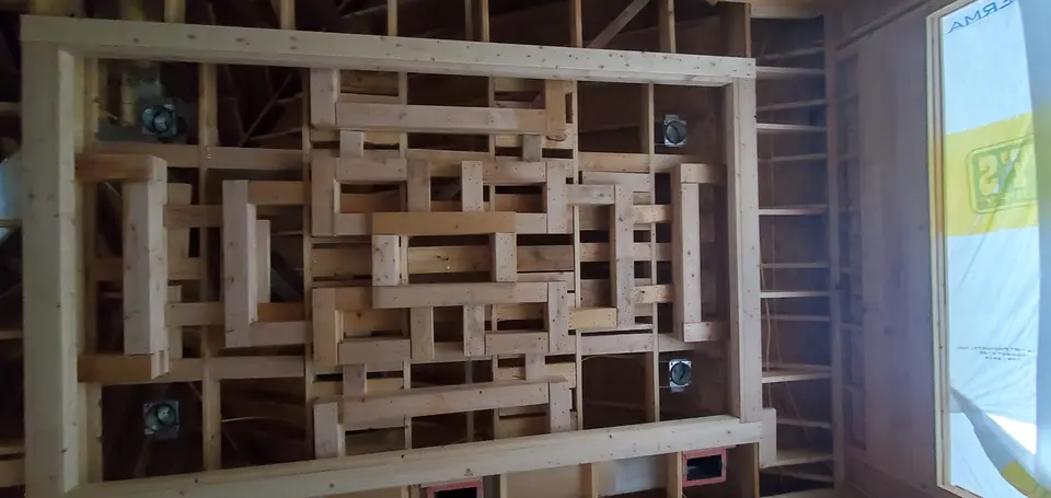 Custom grid-pattern ceiling framing under construction inside a Better Builders home.