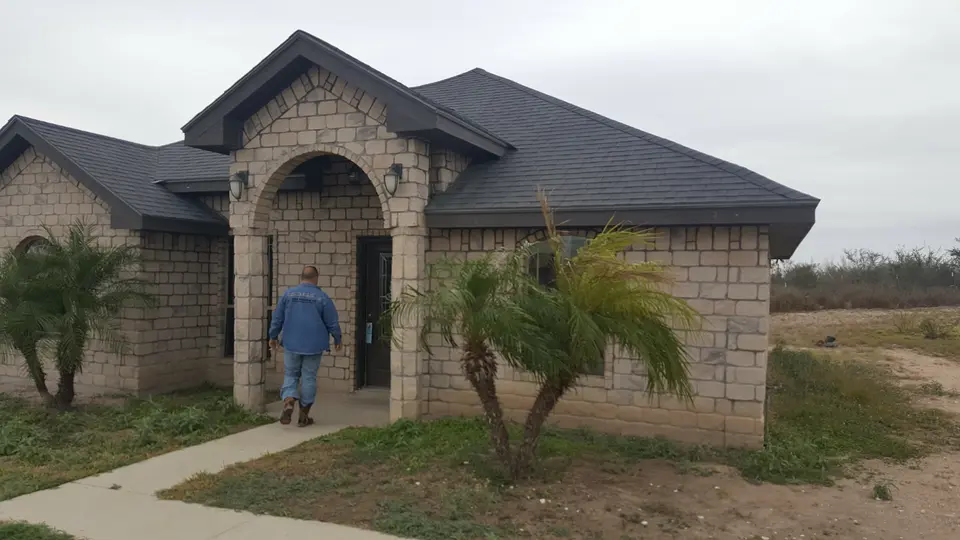 Finished stone home with arched entry
