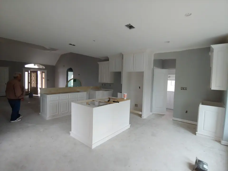 Open kitchen with white island cabinetry