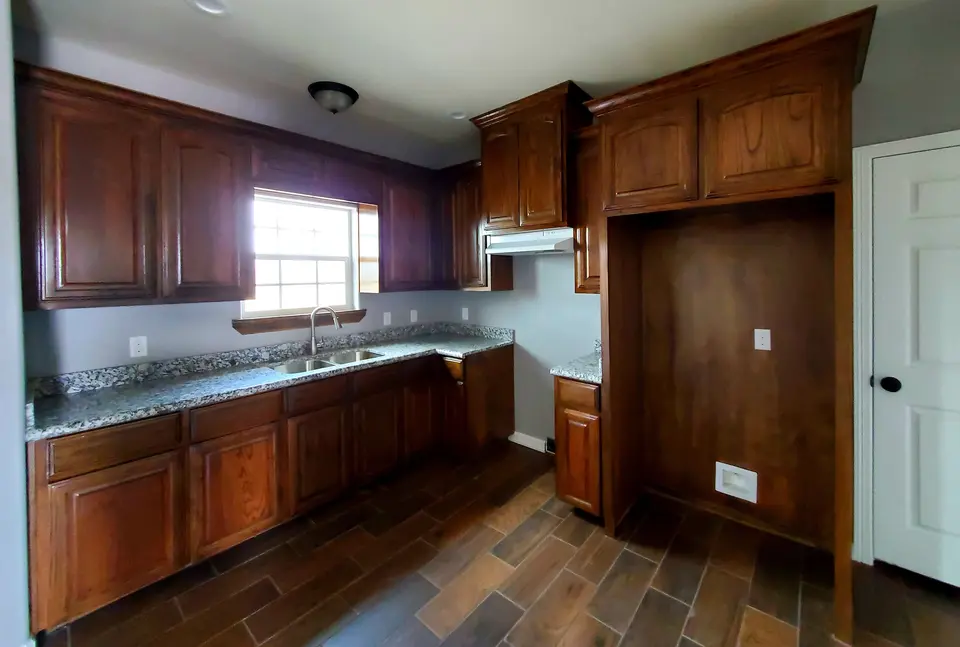 Dark-wood kitchen with granite counters