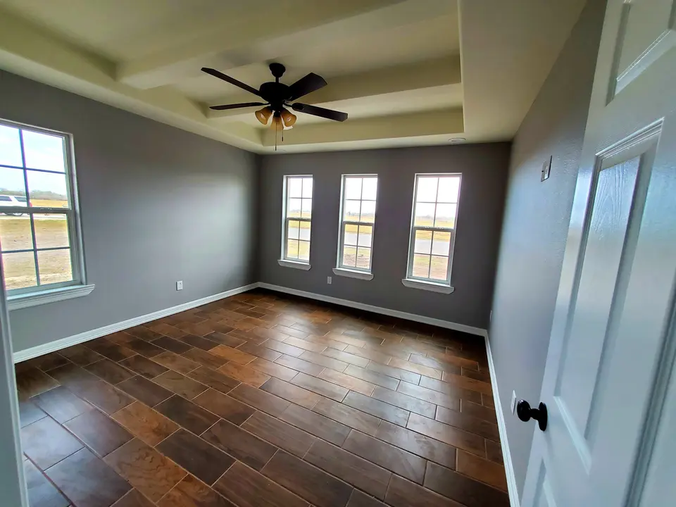 Bedroom with geometric tray ceiling
