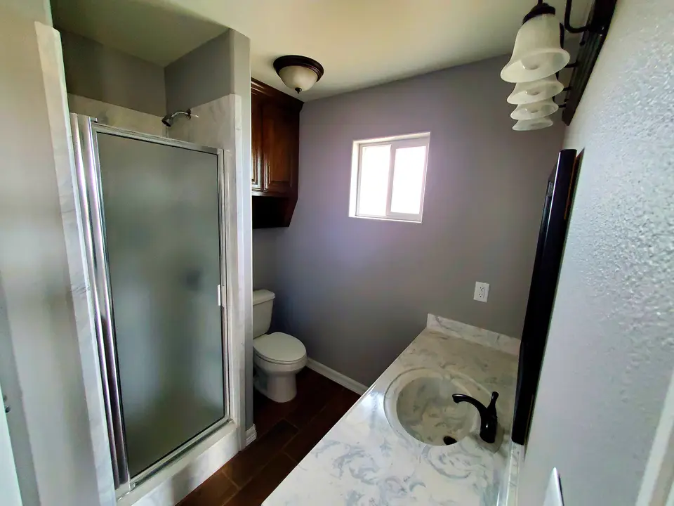 Bathroom with glass shower and vessel sink